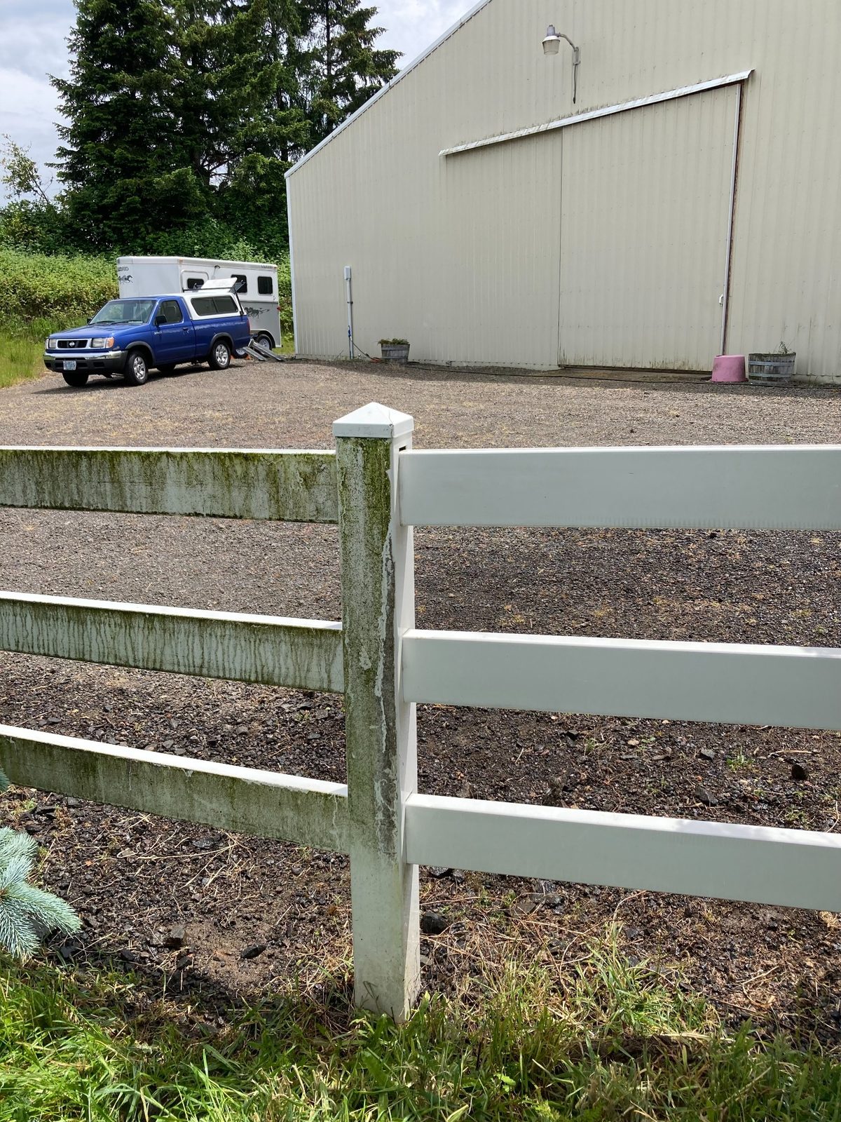 Fence showing clean and dirty sections from washing